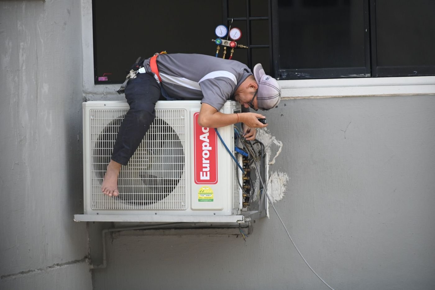 Technician repairing a home air conditioning unit